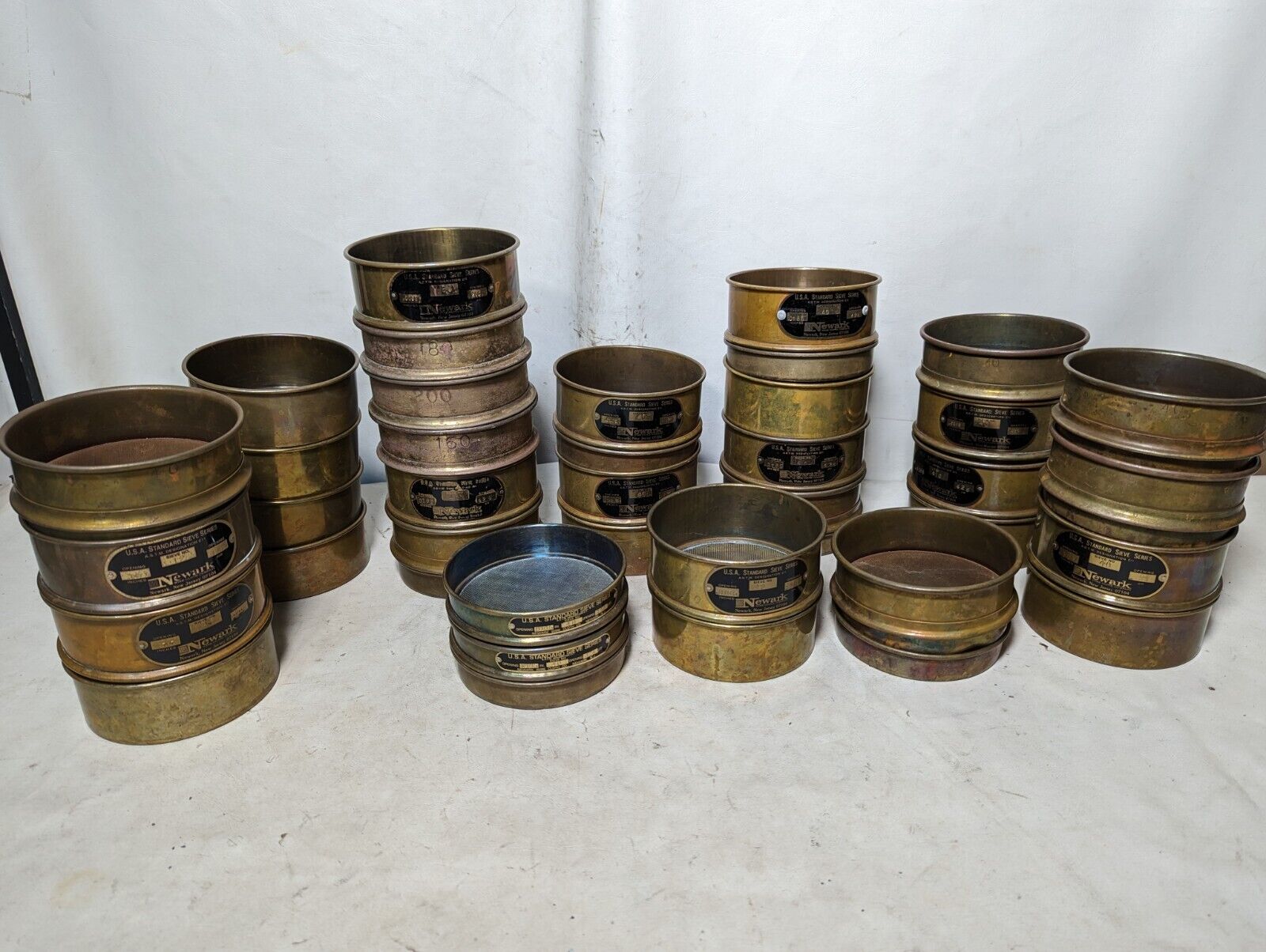 Lot of 37 vintage brass Newark sieves/cups/lids as pictured, USA standard sieve 